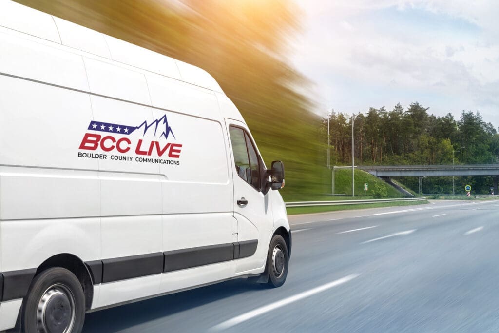 The BCC Live van speeds down the road, in the style of commercial imagery, mountainous vista background