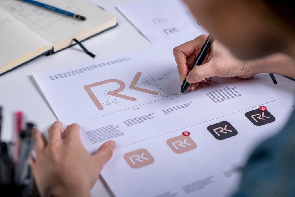 Graphic artist makes revisions on physical copy of design document